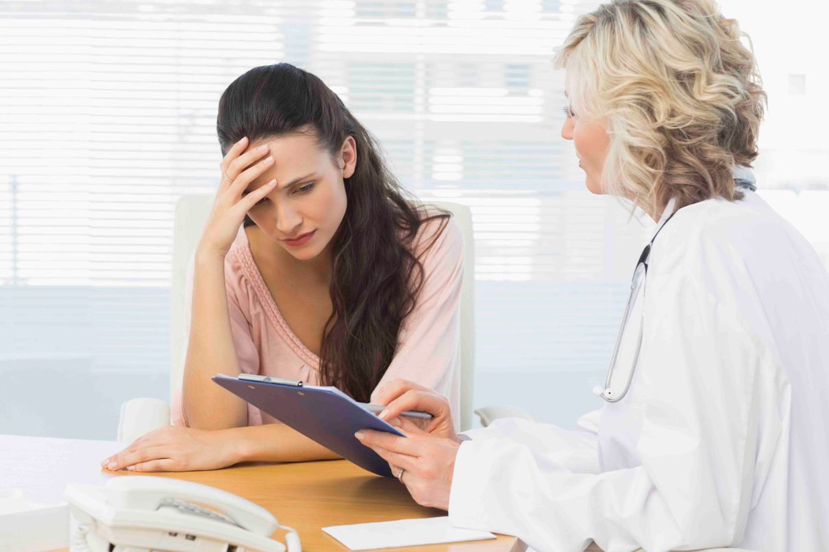 Female doctor discussing reports with patient